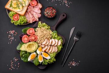 Delicious healthy lunch consisting of chicken, avocado, quinoa, eggs and tomatoes