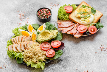 Delicious healthy lunch consisting of chicken, avocado, quinoa, eggs and tomatoes