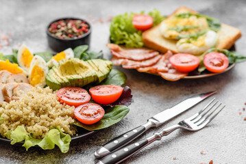 Delicious healthy lunch consisting of chicken, avocado, quinoa, eggs and tomatoes