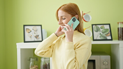 Young blonde woman smiling confident talking on smartphone at home