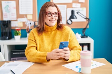 Young beautiful plus size woman business worker using smartphone working at office