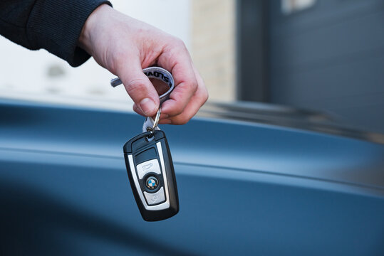 Slovenia, Ljubljana - 31 January 2023: BMW M4 high performance car with hand holding key