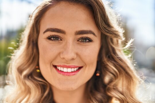 Young woman smiling confident standing at street