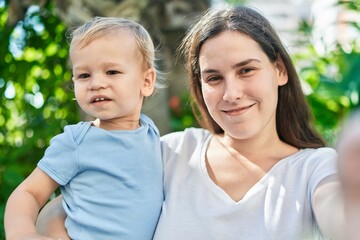 Mother and son smiling confident make selfie by camera at park