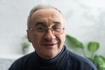 old age, problem and people concept - close up of senior man in glasses thinking.