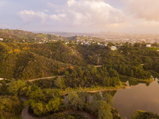 Naklejka premium High-angle views taken from a drone of Lake Hollywood, or Hollywood Reservoir, in the Hollywood neighborhood of Los Angeles, California. Pictures taken after a large rainfall showing the lush foliage.