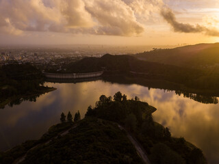 High-angle views taken from a drone of Lake Hollywood, or Hollywood Reservoir, in the Hollywood neighborhood of Los Angeles, California. Pictures taken after a large rainfall showing the lush foliage.