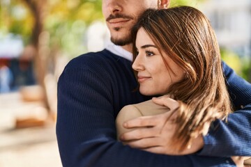 Mand and woman couple hugging each other at park