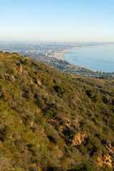 Fototapeta na wymiar Sunset views from the Santa Monica Mountains while hiking, looking down on the city of Los Angeles and the Santa Monica Bay.