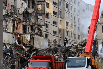 Russian missile strike destroyed residential building, Dnipro, Ukraine. Rescuers are looking for people under rubble of house, rescue equipment, fire. Russian war, Ukraine, Dnepr