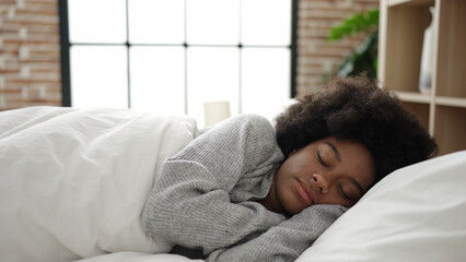 African american woman lying on bed sleeping at bedroom