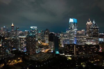 Fototapeta na wymiar Aerial view of downtown district of Atlanta city in Georgia, USA. Brightly illuminated high skyscraper buildings in modern american midtown