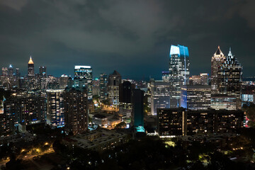 Aerial view of downtown district of Atlanta city in Georgia, USA. Brightly illuminated high skyscraper buildings in modern american midtown