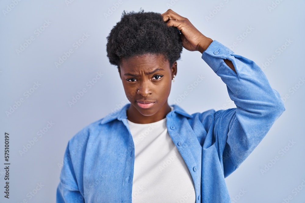 Canvas Prints African american woman standing over blue background confuse and wondering about question. uncertain with doubt, thinking with hand on head. pensive concept.