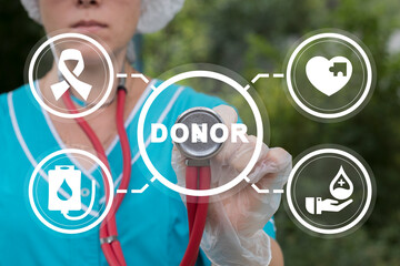 Doctor using virtual touch screen presses word: DONOR. Blood donation. Concept of blood and plasma...
