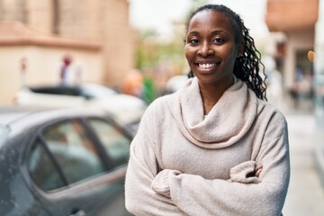 African american woman smiling confident standing with arms crossed gesture at street