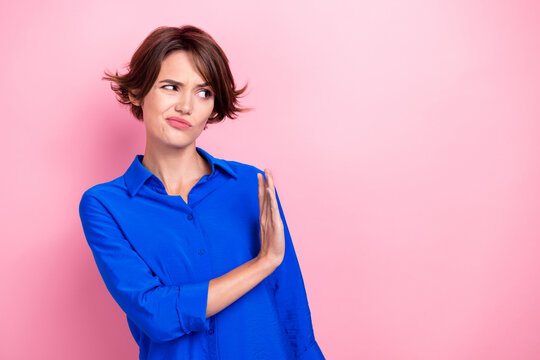 Photo of unsatisfied lady look arm palm reject deny empty space isolated on pink color background