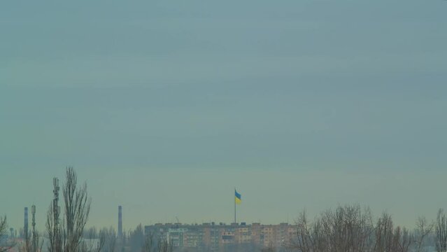 Ukrainian flag wave in the wind flagpole national symbol above city time lapse