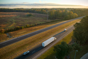 View from above of busy american highway with fast moving trucks and cars. Interstate transportation concept