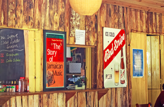 Treasure Beach (Jack Sprat), Jamaica - May 9. 2010: Typical Jamaican Caribbean Restaurant Interior With Wood Walls, Retro Red Stripe Beer Metal Sign