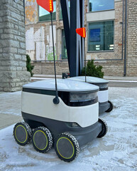 Autonomous delivery robot waiting for order at cafe or restaurant. Technology, unmanned courier...