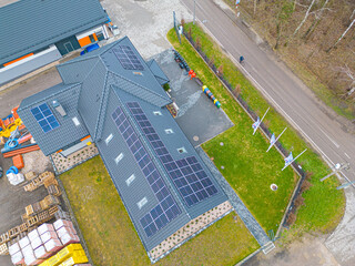 High angle shot of a private house situated in a valley with solar panels on the roof