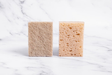 Sponges for washing dishes made of sisal. Two sponges on marble background. Double-sided sponges