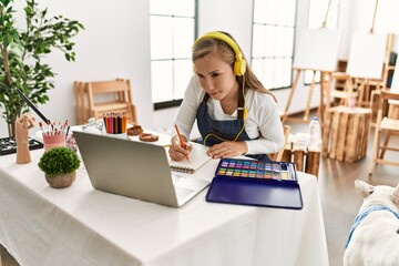 Young caucasian woman having online draw lesson at art studio