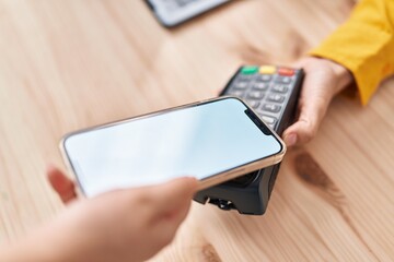 Young woman ecommerce business worker collect using smartphone and data phone at office