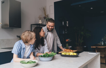 Happy family cooking healthy dish together