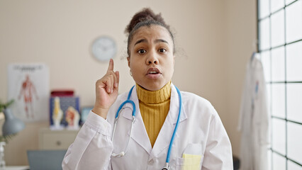 Young african american woman doctor standing having an argument at clinic