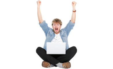Man cheering with laptop computer and arms raised winning happy. Young Caucasian male model sitting on floor isolated in transparent PNG.