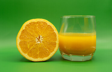 glass of orange juice and orange