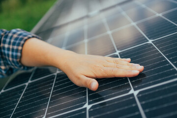 Close up of an young engineer hand is checking an operation of sun and cleanliness of photovoltaic...