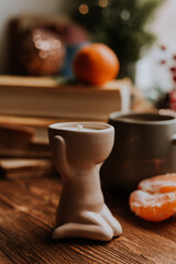 handmade scented candles, coffee, books and tangerines for the New Year. Cozy atmosphere of Christmas at home