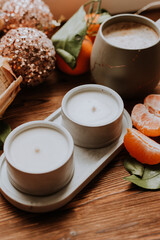 handmade scented candles, coffee, books and tangerines for the New Year. Cozy atmosphere of Christmas at home