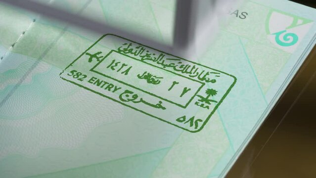 Concept of Legal Travel Around the World. A stamp is placed on the page of the passport and leaves an ink impression of entry into the country. Stamps start to change, showcasing different countries