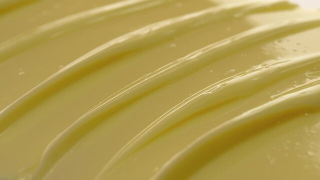 Side view macro texture of yellow night cream with daffodil extract and shea butter | Night cream commercial