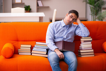 Fototapeta premium Young male student preparing for exams at home