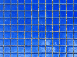 Texture of fine little ceramic tiles background. Mosaic-coated surface with fine square tiles. Texture of fine ceramic tiles close up. Blue floor tiles
