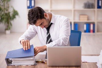 Young male employee working in the office