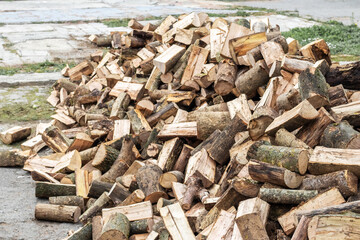 A pile of sawed firewood for heating in winter. Stockpile of firewood during the energy crisis