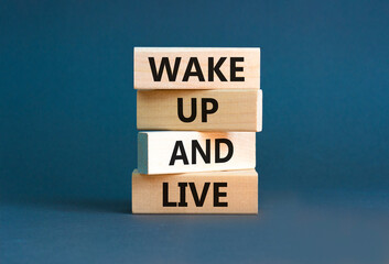 Wake up and live symbol. Concept words Wake up and live on wooden blocks. Beautiful grey table grey...