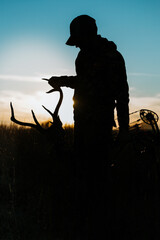 Fototapeta na wymiar silhouette of a bow hunter with antlers