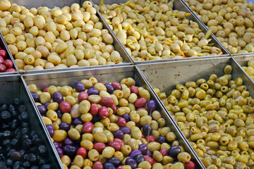 variety selection of marinated and pickled olives in a food stall for selling