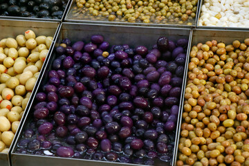 variety selection of marinated and pickled olives in a food stall for selling