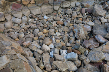 Dry stones at the bottom of an artificial reservoir before the fountain starts. Background with...