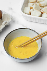 Bread pudding with caramel sauce on top. White background.