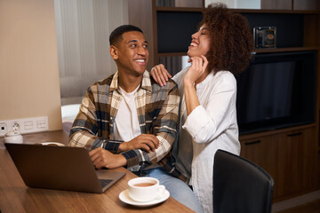 Guy and his girlfriend are having fun chatting over morning coffee