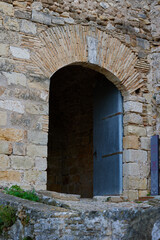 Fototapeta na wymiar High gate to the ancient stone fortress